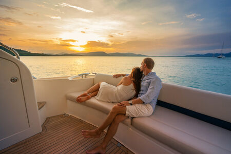 couple sitting on yacht watching sunset